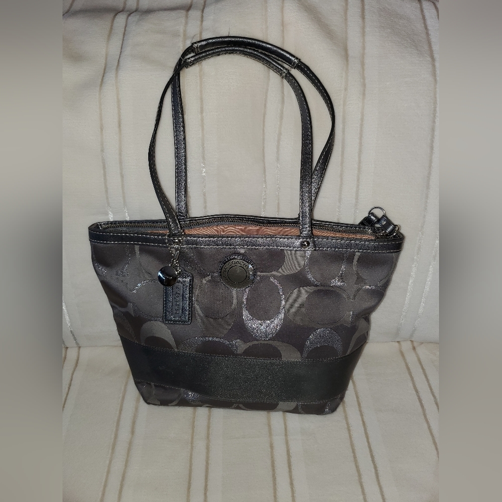 Grey Coach bag with silver monogram logo.